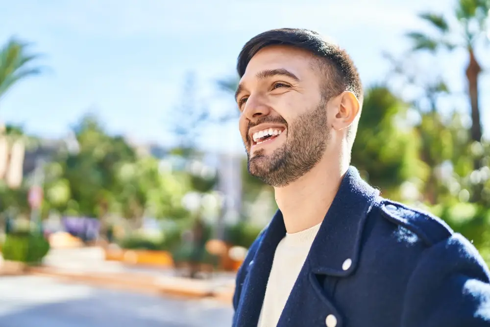 Laughing man outdoors on a sunny day