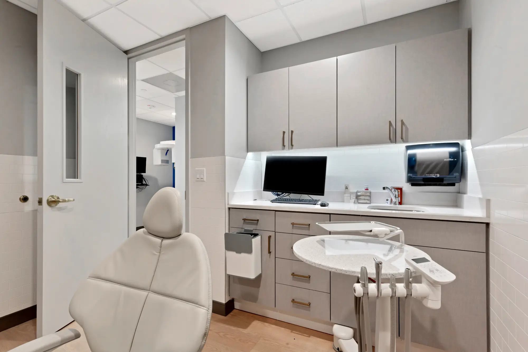 Treatment room with dental chair, monitor and cabinets