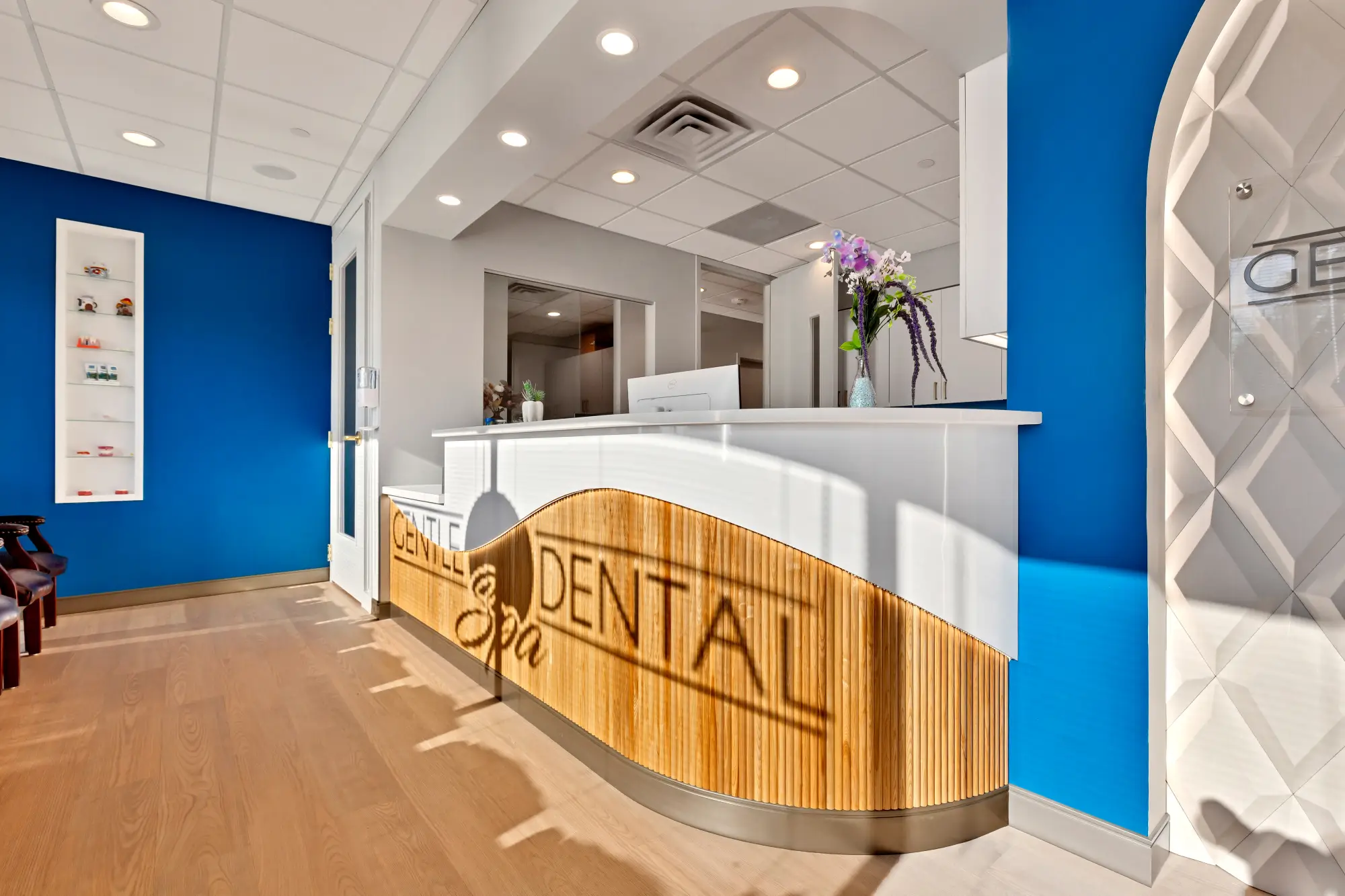 Reception desk with the Gentle Dental Spa name on its wooden front