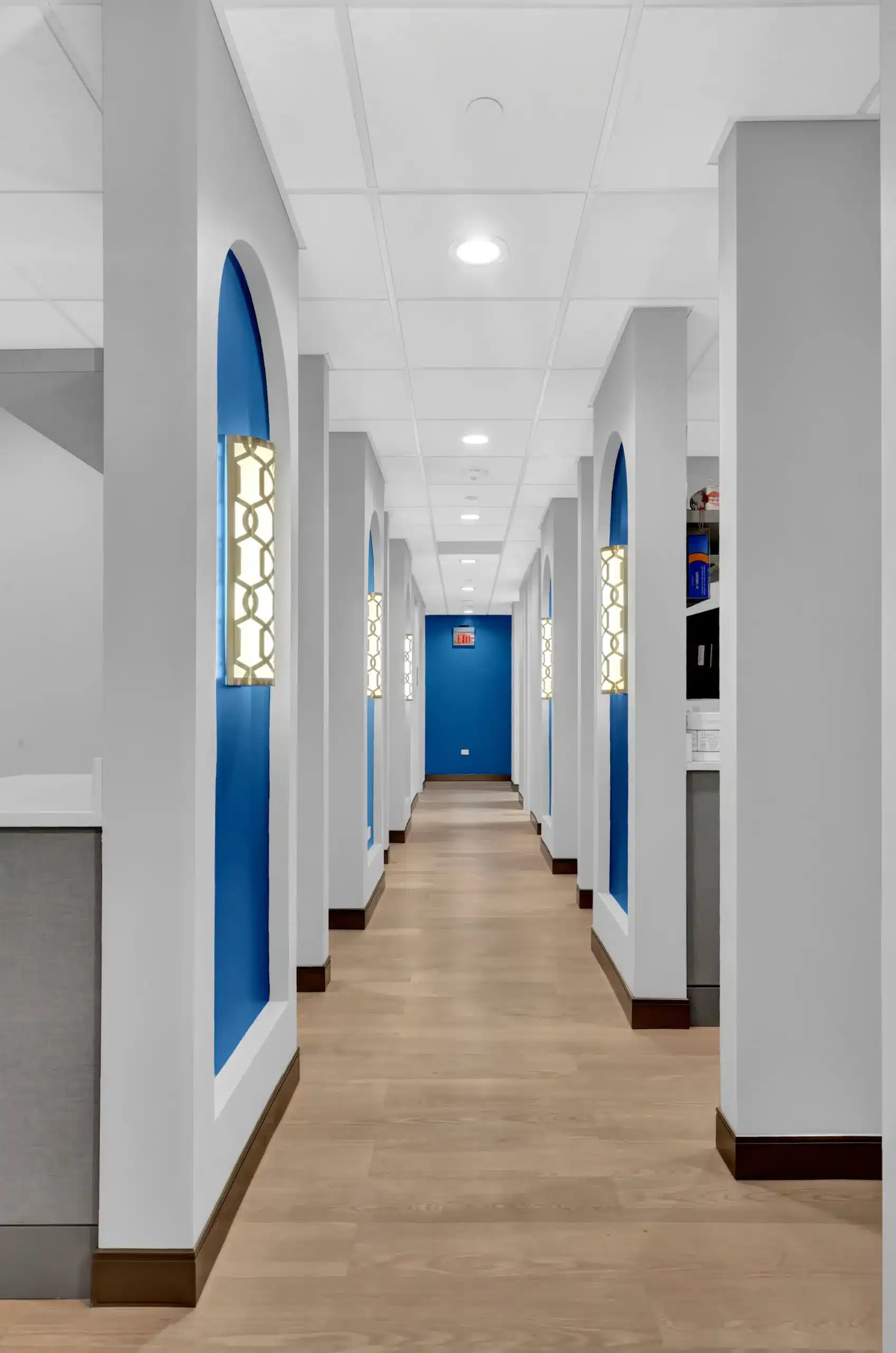 Hallway to the treatment rooms with blue arched niches