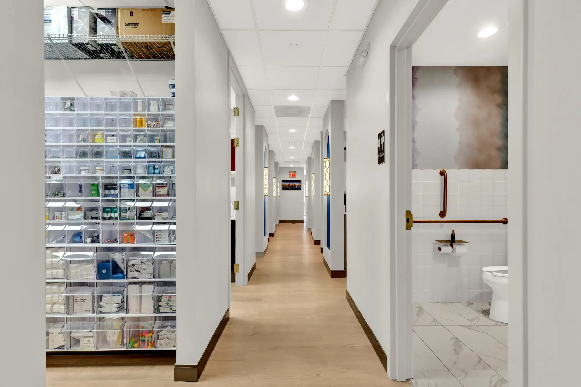Hallway with the supply room on one side and a restroom on the other
