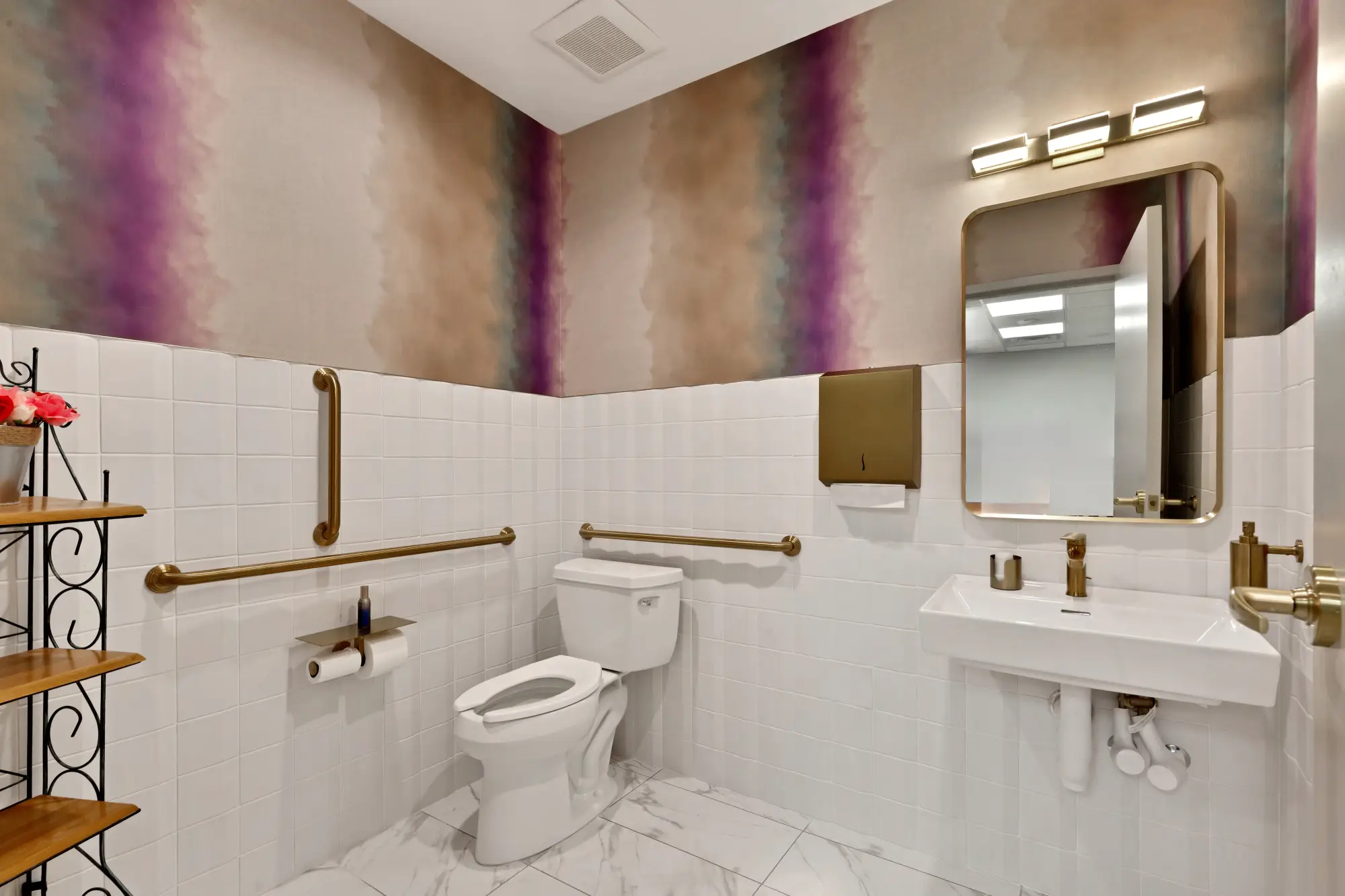 Restroom with grab bars, mirror and shelving