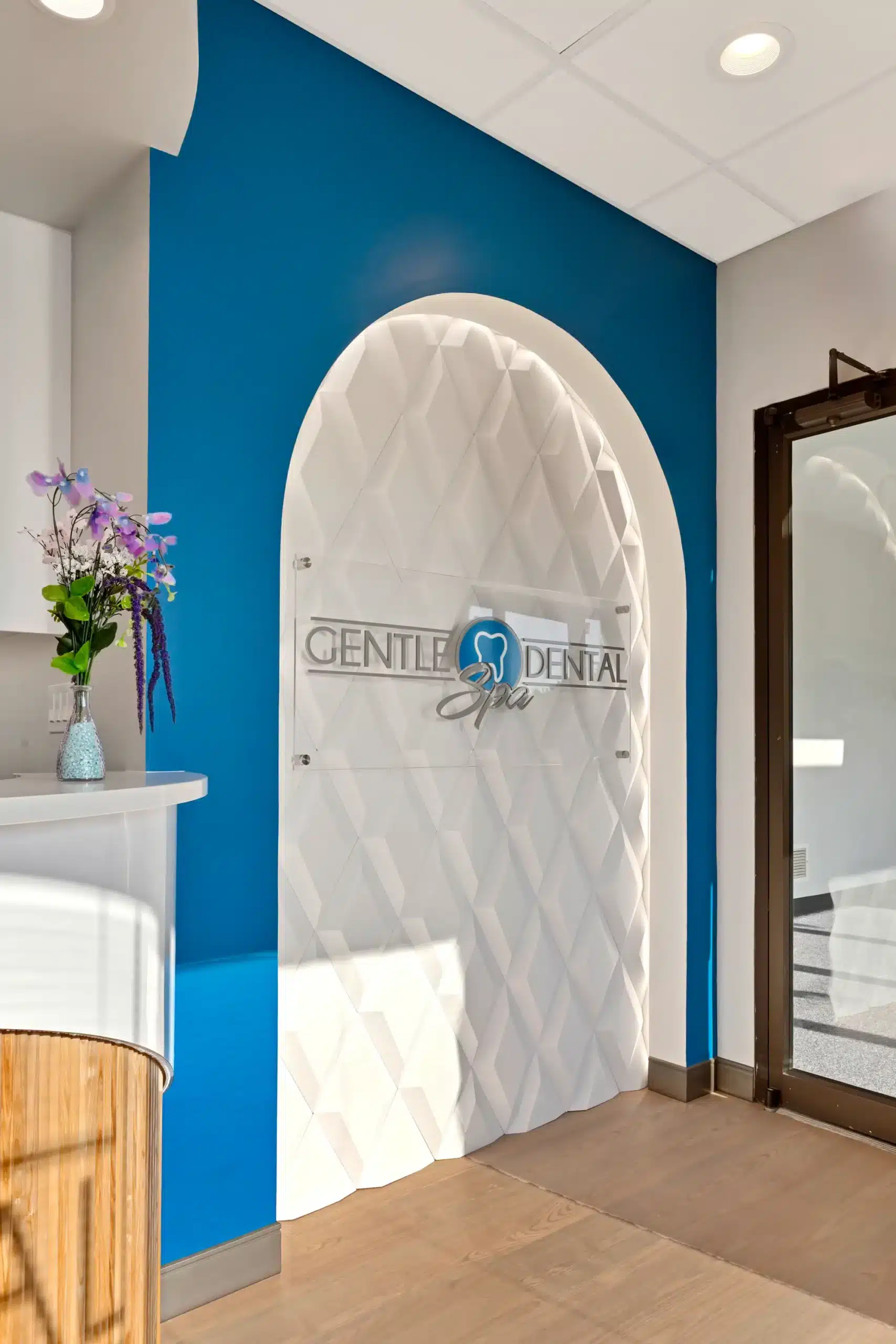 Illuminated Gentle Dental Spa logo wall beside the entrance