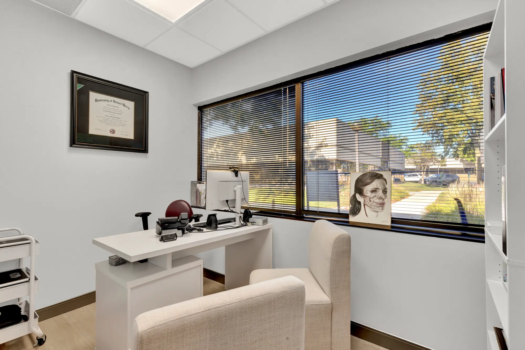 Private office with desk, armchairs and a framed diploma