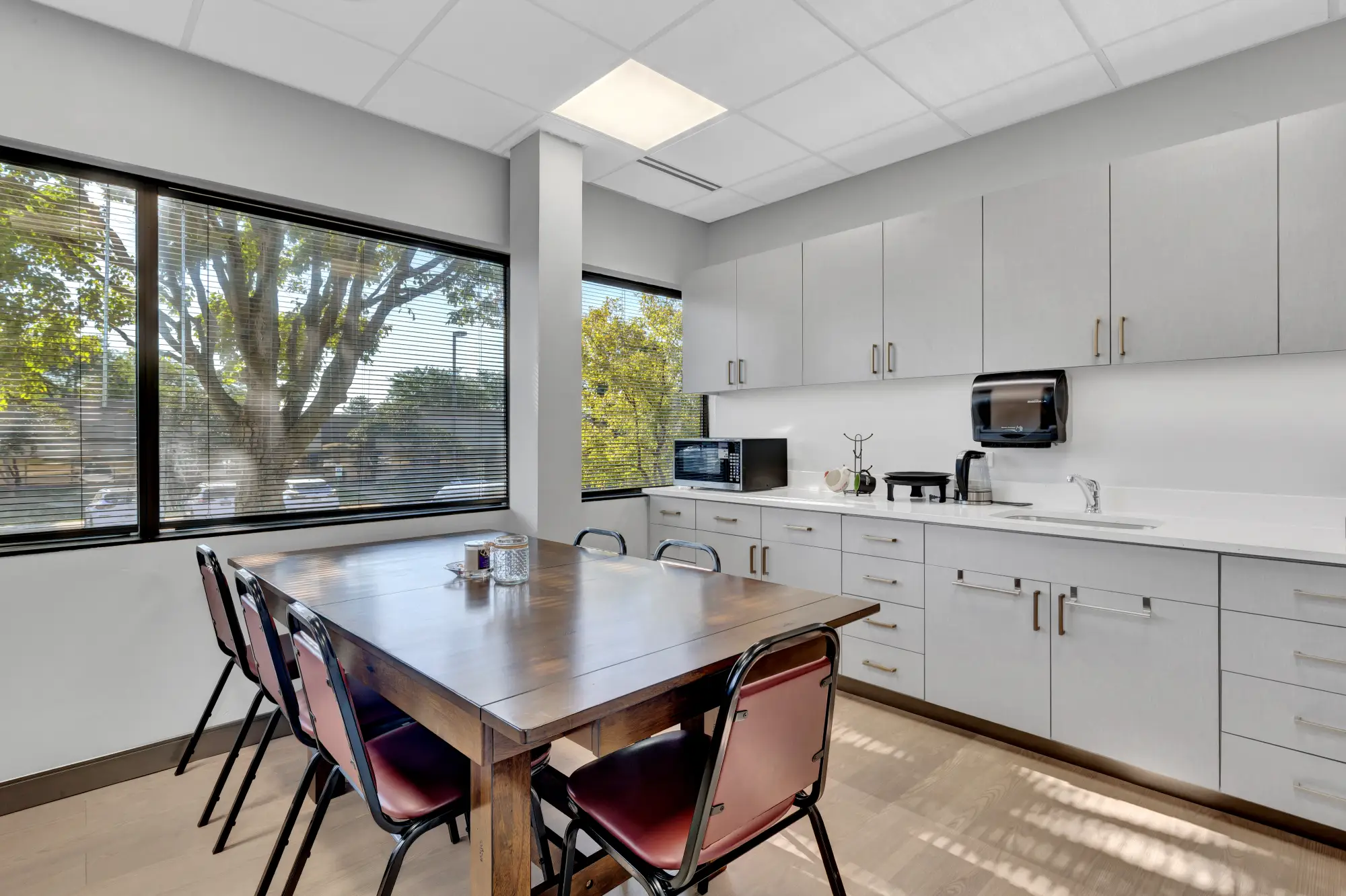 Staff break room with dining table and kitchenette