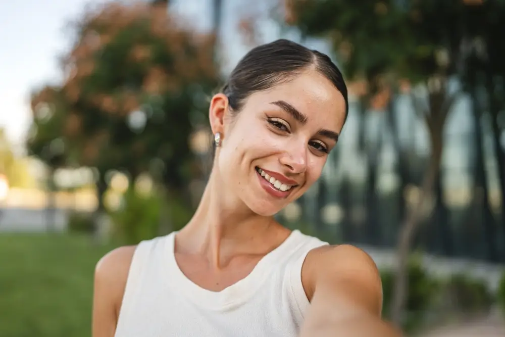 Smiling woman taking a selfie outdoors