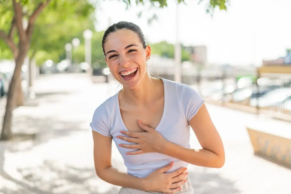 Laughing young woman outdoors