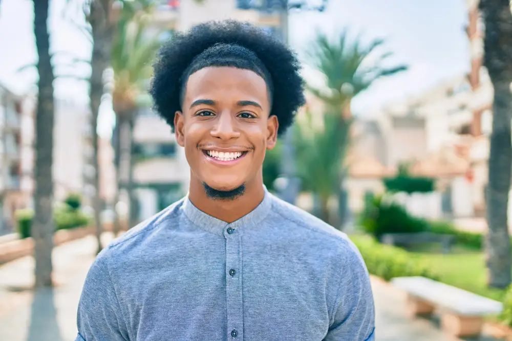 Smiling young man outdoors on a sunny day